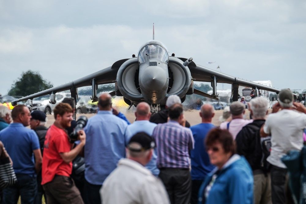 front of a harrier with a crowd of people photograping it